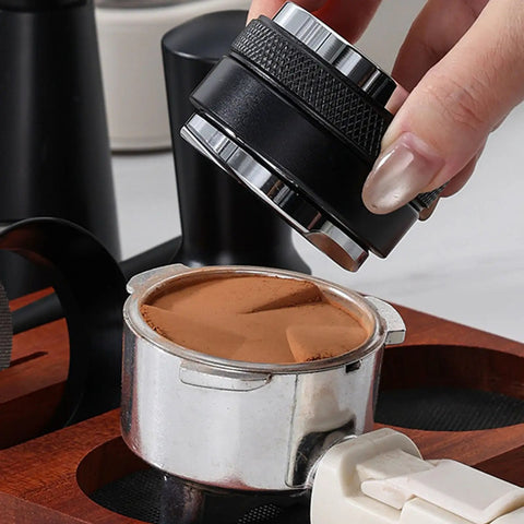 Top Shelf Espresso Setup 51mm Spring Loaded Tamper Set with black tamper over coffee grounds in metal portafilter.