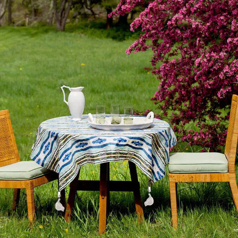 Outdoor table with tablecloth held by Clip On Tablecloth Weights Set Of Four Heavy Duty Cast Iron Bird Weights With Stainless Steel Clips
