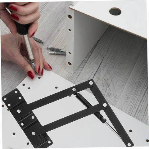 Black heavy-duty lift-up self-closing hinge being installed on white drop-leaf panel; 1 pair with screws.