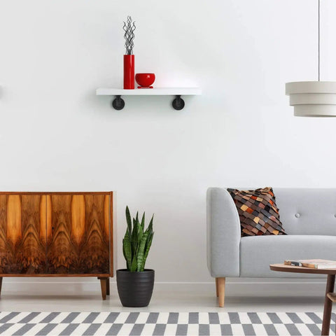 Living room with a wall-mounted shelf supported by a Half Inch Pipe Shelf Bracket Set Of 4 For Wall Mounted Floating Shelves Industrial Rustic Decor.