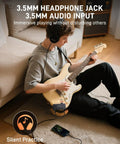Person using Mini Guitar Headphone Amplifier With 3.5mm Aux Jack For Silent Practice And On The Go Travel Real Analog Tone Distortion Timbre