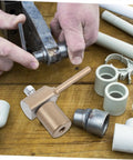 Person using PPR Repair Tool With Hot Melt PE Welding Rods for Quick Leak Fixes, DIY pipe fittings on wooden table