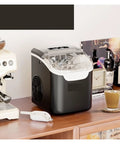 Countertop Ice Maker Portable Bullet Machine Makes Fresh Ice In Minutes on a wooden countertop next to a coffee machine.