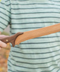 Child holding DIY Wooden Knife Making Kit For Kids Teens And Adults - Real Wood Craft Gift with hardwood blade and handle.
