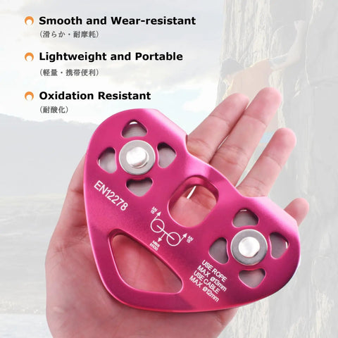 Badass Heavy Duty Zipline Pulley With 6700 Lbs Load Rating And Buttery Smooth Double Bearings seen in hand, red anodized aluminum design.