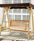 Wooden outdoor swing with brown canopy and chains on a patio background.