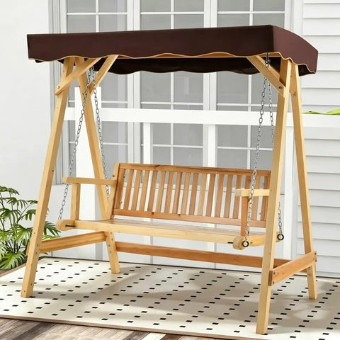 Wooden outdoor swing with brown canopy and chains on a patio background.