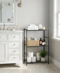 Three Tier Metal Storage Shelf Organizer For Small Spaces With Adjustable Feet Space Saving Heavy Duty Shelving Unit For Kitchen Garage And Laundry Room Each Shelf Supports Up To 100 Lbs Black, shown next to a bathroom sink, holding towels and toiletries.