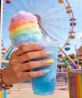 Hand with Six Candy Colors Gel Nail Polish Set HEMA Free TPO Free Soak Off Gel Polish in pastel shades holding a blue drink
