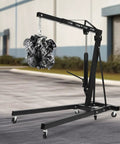 Built Tight 2 Ton Folding Engine Hoist Featuring Snap Fold Hydraulic Shop Crane lifting an engine in a garage setting.