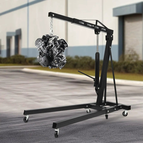 Built Tough Two Ton Hydraulic Engine Hoist With Folding Cherry Picker Design lifting an engine in a garage setting.