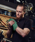 Man in workshop using Heavy Duty Shop Towels 50 Pack Green Terry Cloth Rags For Car Detailing And Home Cleaning Highly Absorbent Washable Towels