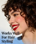 Close-up of a smiling woman with curly hair wearing red lipstick demonstrating hair styling techniques with 50 Pack Heavy Duty Metal Pin Curl Clips With Three Essential Loc Combs For Strong Braid Support Flex And Twist Mastery That Slays On Every Crown.