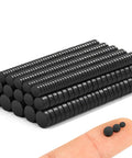 Stacks of tiny but mighty black rare earth magnets set with 400 pieces in 3 sizes for crafts fridge notes miniatures office organization.