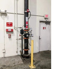 Industrial fire sprinkler system next to exit door with signs for 7 In 1 Fire Sprinkler Shutoff Tool Kit With Wall Cabinet Case.