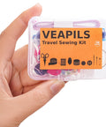 Travel Sewing Kit Grab And Go 38 Piece Portable Emergency Sewing Set held in hand with multicolor threads and tools visible.
