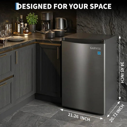 3.1 Cu Ft Upright Freezer With Sleek Stainless Steel Finish in a modern kitchen corner, showing dimensions 34.45 x 21.26 x 20.71 inches.