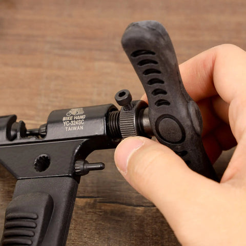 Pro Grade Bike Chain Rivet And Breaker Tool with Spare Driving Pin in use, focusing on tool mechanism and adjustment details.