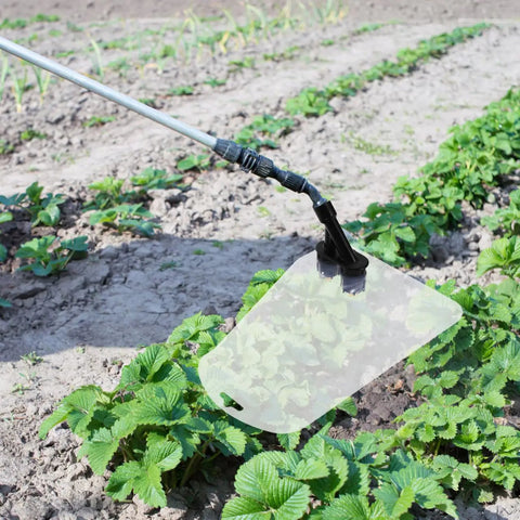 Electric Sprayer Nozzle With Windproof Shield For High Pressure Atomizing Mist in use over garden plants, 15.75 inch length.