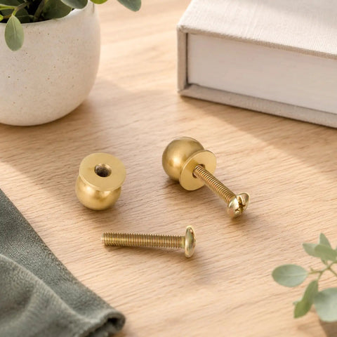 Real Deal Quality Top Shelf Solid Brass Mini Knobs One Half Inch Gold Drawer Pulls Four Pack With Screws on wood surface