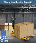 Heavy Duty Electric Pallet Truck With 4400 Lb Capacity For Tough Warehouse Work lifting wooden crates in warehouse.