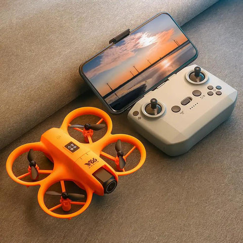 Orange palm sized FPV drone with dual cameras beside a remote, showing easy one key takeoff and app control on a smartphone screen.