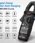 True RMS Clamp Meter For Auto Ranging 6000 Counts With 600A Capacity And Built In Flashlight Backlight Measures NCV AC DC Voltage And Current Continuity Capacitance Diode Resistance And Temperature For Car Home And Industrial Fixes. Black digital clamp meter with LCD display.