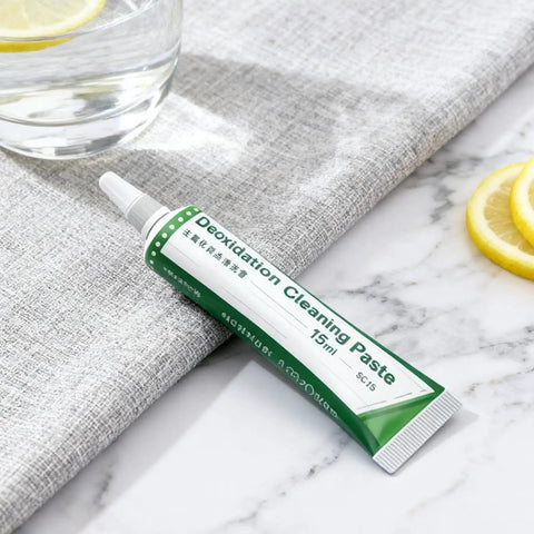 Flux Paste For Soldering, 15ml tube, placed on a marble surface next to a grey cloth and lemon slices, improves conductivity.