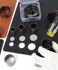 Leather Circle Cutter Tool Set With 21 Sizes From 15 To 55 Mm for leather crafts, punch dies displayed with hammer and cutouts.