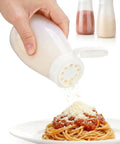 Top Shelf Soft Parmesan Cheese Shaker Set Squeezable Spice Jars With Wide Opening Heavy Duty Plastic Seasoning Dispensers pouring cheese over pasta.