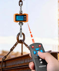 Beast Of A Digital Crane Scale With 4400 Lbs Capacity in use, showing LCD display and remote control in industrial setting.