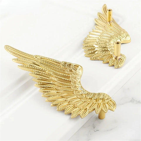 Solid Brass Angel Wing Cabinet Knobs With A Slick Matte Gold Plating, close-up view, unique design, pack of two.