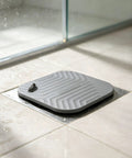 Shower Drain Cover Tub Stopper Square Silicone Floor Drain Cover positioned in a wet shower area, measuring 5.9x5.9 inches.