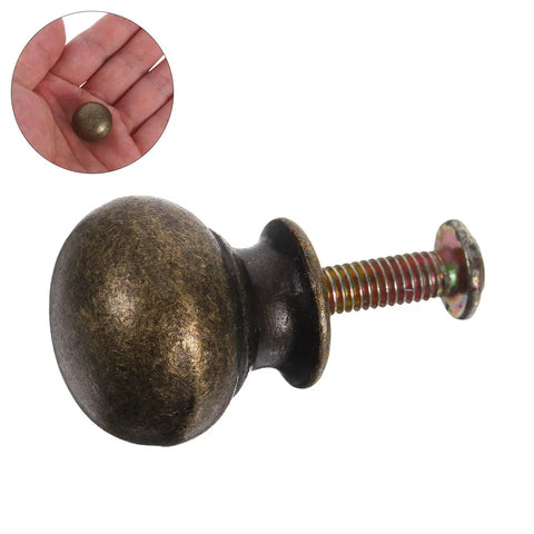 Stylish European Retro Clock Door Knobs In Antique Bronze Tone With Screws Perfect For Vintage Cabinet Hardware And Repair Projects That Give Your Space Serious Old World Charm And Sophistication. round bronze cabinet knob with screw, close-up in hand