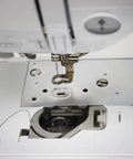 Front view bobbin cover plate on white sewing machine with presser foot
