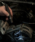 Hand using Strion LED HL 615 Lumen Rechargeable Professional Flashlight With 120 Volt AC And 12 Volt DC Charger in engine bay