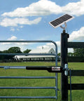 10W 12V Solar Battery Charger Maintainer with Smart MPPT Controller mounted on a gate post in a farm setting
