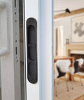 Replacement Sliding Screen Door Handle And Latch With Keeper In Black Zinc Alloy, shown installed on a sliding door indoors.