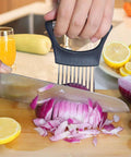 Hendiy onion slicer holder with black handle and metal tines, slicing red onion on cutting board