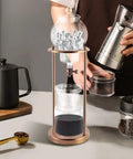 Chill Mode Ice Cold Brew Dripper Coffee Maker Featuring 600ml Borosilicate Glass And Stainless Steel Slow Drip Extraction System with ice and coffee beans.