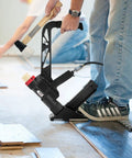 Man using Two In One Pneumatic Flooring Nailer And Stapler For Hardwood And Engineered Floors With Fifteen And A Half Gauge Staples