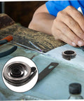 Craftsman using Vintage Mechanical Alarm Clock Repair Kit With Precision Steel Parts And Winding Key on wooden workbench