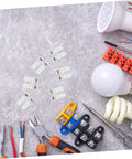 55 Piece Spring Clamp Terminal Blocks And Wire Connectors Kit for LED lighting wiring with tools on a stone surface.