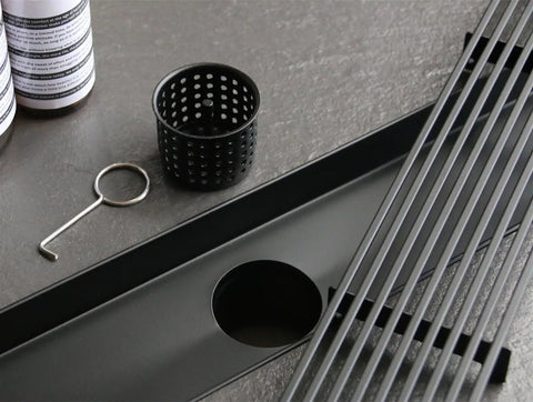 28 Inch Linear Shower Drain With Removable Wedge Wire Grate Matte Black 304 Stainless Steel Rectangle Shower Floor Drain For Bathroom CUPC Certified With Hair Strainer For Fast Easy Drainage showing the grate and hair strainer.