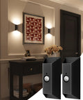Wireless Motion Sensor Wall Light With Remote Control Rechargeable Led Sconce in black, mounted on a wall beside artwork.