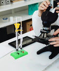 Hydrogen Water Electrolyzer Hands On Electrolysis Demonstration Educational Kit beside a microscope in a science lab