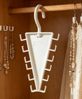 Slick V Shaped Double Sided Clothes Hanger With Twelve Hooks for Dig Free Closet Organization And Rotating Wardrobe Storage, hanging in a closet.