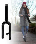 Scooter Front Wheel Fork Replacement Part With Alloy Wheel Bracket For 30 Electric Scooters EZ Install Rustproof And Wear Resistant Lightweight And Durable Front Fork For Quick Maintenance Black Finish shown next to a woman riding a scooter.