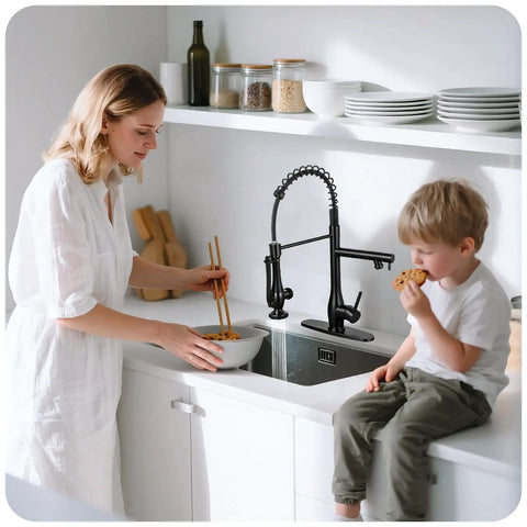 RNDIOZD Kitchen Faucet with Pull Down Sprayer, 2-Spout, Matte Black used by a woman with chopsticks in a modern kitchen.