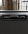 Zero Drama Quick Fix Suitcase Telescopic Handle Release Button For Broken Luggage Trolley Pull Mechanism on a black suitcase.
